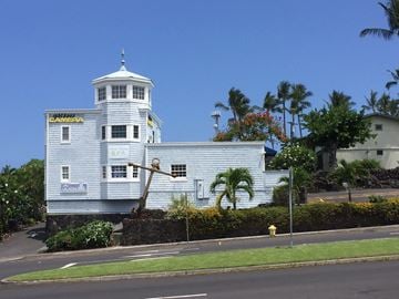 Kailua-Kona apartment for rent - a white building with a tower on top of it on a street