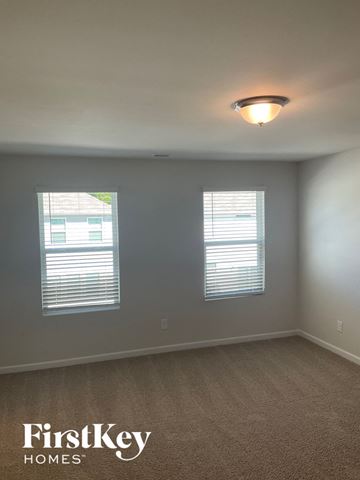 Charlotte house for rent - a bedroom with two windows and a ceiling light