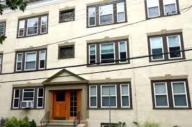 Cambridge condo for rent - A building with a brown door and windows.