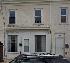 Chester apartment for rent - A car is parked in front of a white house.