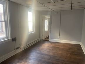 Chester apartment for rent - A room with wooden floors and white walls.