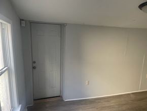 Chester apartment for rent - A room with a white door and a window with white curtains.