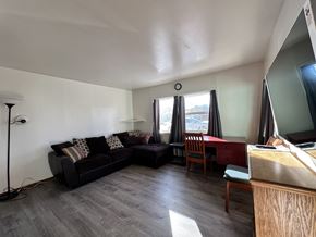 Sitka house for rent - A living room with a couch, chair, and desk.