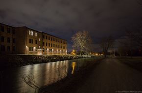 Goshen apartment for rent - a city street at night with buildings and a river
