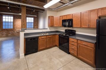 Goshen apartment for rent - a kitchen with black appliances and wooden cabinets