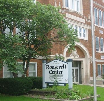 Elkhart apartment for rent - a building with a center sign in front of a tree