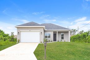 Port Charlotte house for rent - A house with a white garage door and a grey roof.