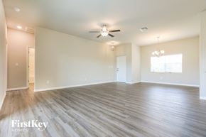 Port Charlotte house for rent - A spacious room with wooden flooring and a ceiling fan.