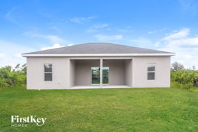Port Charlotte house for rent - A house with a grey roof and a white exterior is shown with the words "FirstKey Homes" on the bottom left.