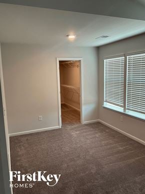 Greenville house for rent - an empty room with a door to a closet and a window