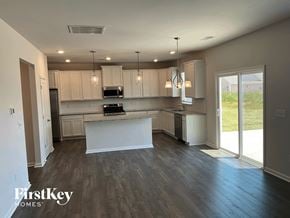 Greenville house for rent - a kitchen with white cabinets and a white counter top