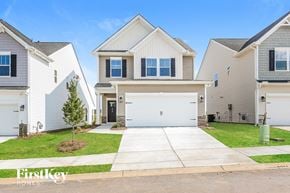 Simpsonville house for rent - A row of houses with a tree in front of the first one.