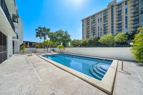 North Miami apartment for rent - a swimming pool on a patio next to an apartment building