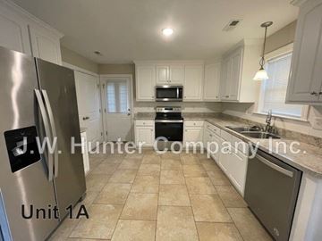 Wilson apartment for rent - A kitchen with a refrigerator and a microwave.