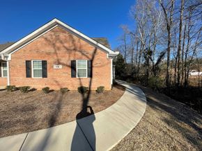 Wilson apartment for rent - A house with a driveway and trees in the background.