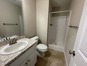 Wilson apartment for rent - A bathroom with a sink, toilet, and shower.