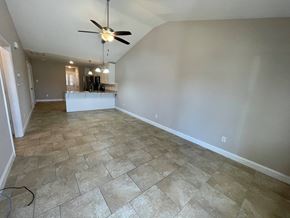 Wilson apartment for rent - A room with a ceiling fan and tiled flooring.