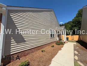 Wilson apartment for rent - A building with a corrugated metal wall and a sign that reads "Unit A".
