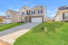 Greenville house for rent - a house with a driveway and a lawn in front of it