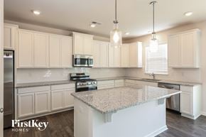 Greenville house for rent - a white kitchen with granite counter tops and white cabinets