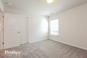 Greenville house for rent - a bedroom with white walls and a white door and a window