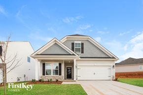 Greenville house for rent - a white house with a gray roof and a lawn