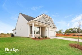 Greenville house for rent - a white house with a lawn in front of it
