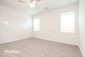 Greenville house for rent - a bedroom with a carpeted floor and two windows