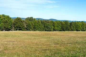 Brookings apartment for rent - a field of grass and trees with mountains in the background