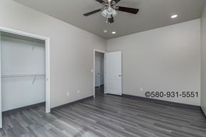 Durant apartment for rent - A room with a ceiling fan and a door.
