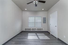 Durant apartment for rent - A room with a ceiling fan and a door.