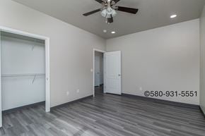 Durant apartment for rent - A room with a ceiling fan and a door.