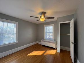 Roanoke apartment for rent - A room with a ceiling fan and a window with blinds.
