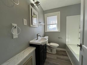 Roanoke apartment for rent - A bathroom with a toilet, sink, and bathtub.