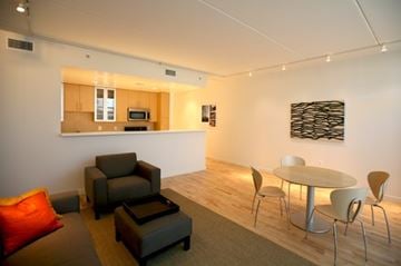 Washington apartment for rent - A modern living room with a grey couch and a white table.