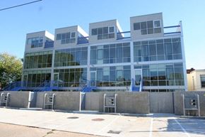 Washington apartment for rent - A modern building with a glass facade and a blue sky in the background.