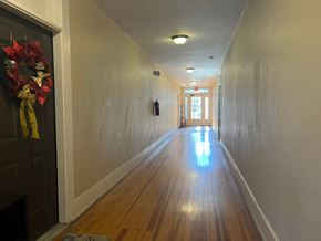 Roanoke apartment for rent - A long hallway with a wreath on the door.
