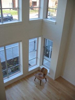 Washington apartment for rent - a chair sitting in the corner of a room with windows