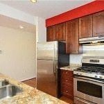 Washington apartment for rent - a kitchen with stainless steel appliances and wooden cabinets