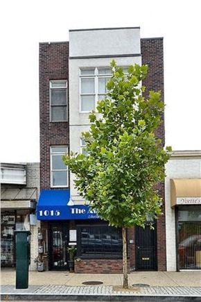 Washington apartment for rent - a building on the side of a street with a tree