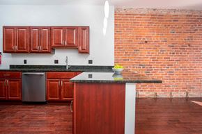 Washington apartment for rent - a kitchen with a brick wall and a counter top