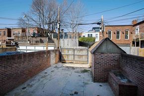 Washington apartment for rent - a back yard with a fence and a brick wall and a wooden fence