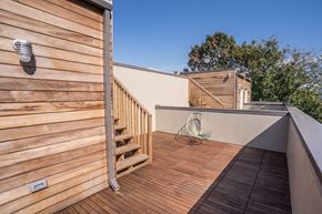 Washington apartment for rent - a balcony with a chair and a wooden deck