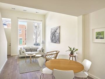 Washington apartment for rent - a dining room and living room with a table and chairs