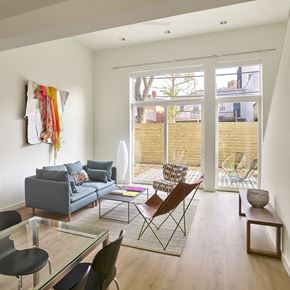 Washington apartment for rent - a living room with a couch and chairs and a glass table