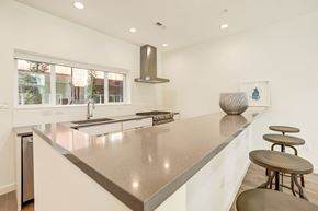 Washington apartment for rent - A modern kitchen with a stainless steel countertop and bar stools.