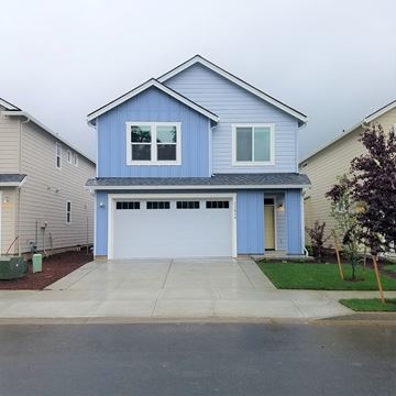 Vancouver house for rent - a blue house with a white garage door