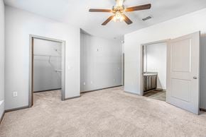 Chattanooga apartment for rent - A spacious room with a ceiling fan and carpeted floor.