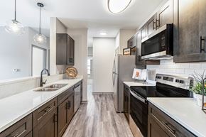 Chattanooga apartment for rent - A kitchen with dark wood cabinets and stainless steel appliances.