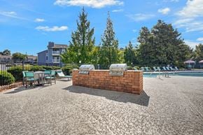 Augusta apartment for rent - A sunny day at the pool with a red brick structure in the middle.